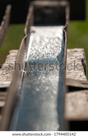 wet rusty channel on a wooden workbench
