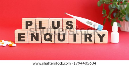 The words PLUS ENQUIRY is made of wooden cubes on a red background with medical drugs. Medical concept.
