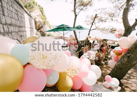 Bundles of helium balloons in pastel pink colors to decorate a wedding party.