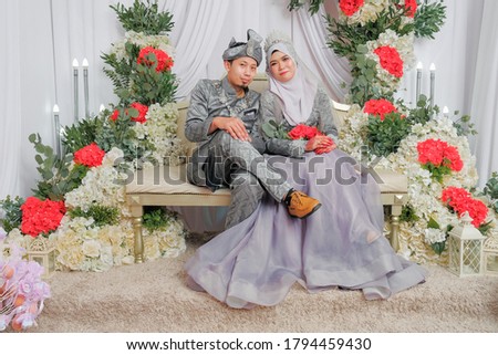 Muslim wedding couple wearing Malay traditional clothing on wedding ceremony.  HAPPY  & FAMILY CONCEPT