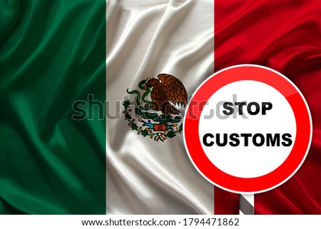 customs sign, stop, attention on the background of the silk national flag of mexico country, concept of border and customs control, violation of the state border, tourism restrictions
