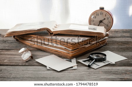 Albums with old family photos on a wooden table. Memories of the past.