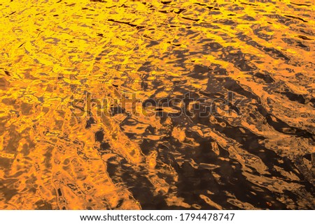 Background orange water surface. Aqua blurred texture.