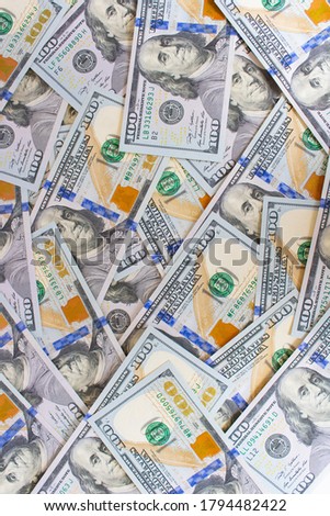 Lots of new hundred dollar bills folded evenly, vertical photo, background