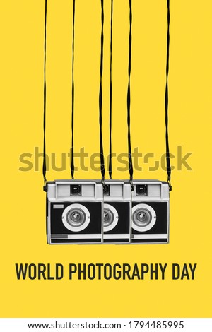 some retro film cameras, in black and white, and the text world photography day on a yellow background