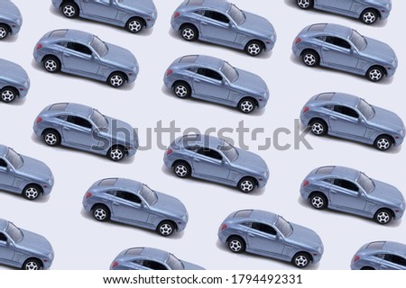 blue  toy cars isolated on grey background. objects in pattern. minimal image.