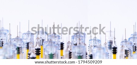 Panoramic View Of A Row Of Various Bright Syringes. Research, Medicine, pharmacy And Health Care