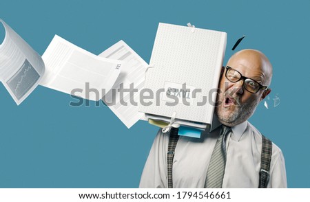 Flying paperwork hitting and hurting a businessman's head, unexpected payments and crisis concept Royalty-Free Stock Photo #1794546661