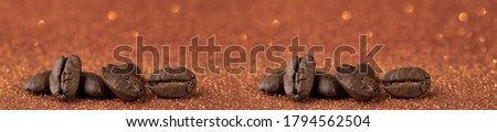 Coffee beans on trendy orange shiny background. Panorama very large Maragogipe coffee beans. Trendy iridescent saffron background.