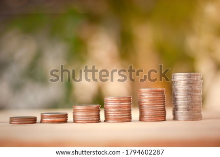 Saving Money concept for Financial, Investment and Business with money coin stack for growing with sun light bokeh background.