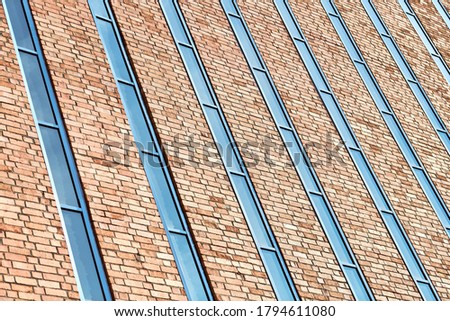 Multistorey building. Rhythm in photography. Multi-storey facade, windows and block of flats, close up. Modern apartments in high raised building. Angle perspective.