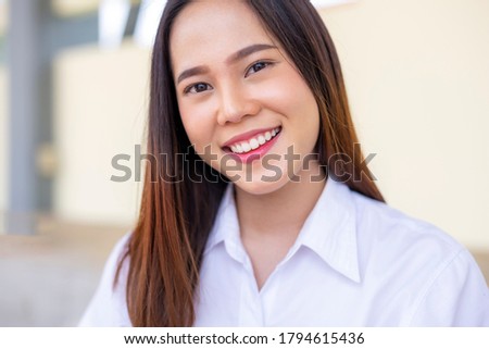 Portrait of beautiful young Asian woman smiling and looking to camera