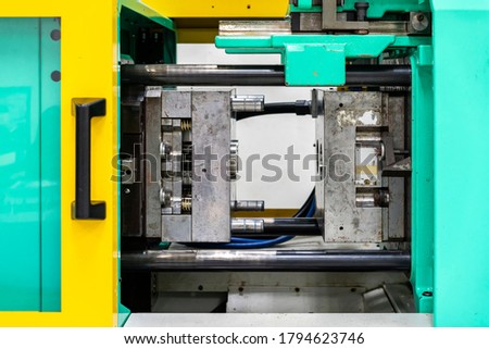 metal mould or plastic injection mold setup on high pressure injection molding machine for mass production or manufacturing in industrial Royalty-Free Stock Photo #1794623746