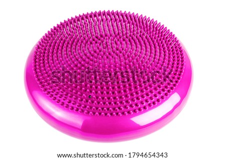 Pink inflatable balance disk isoleated on white background, It is also known as a stability disc, wobble disc, and balance cushion.