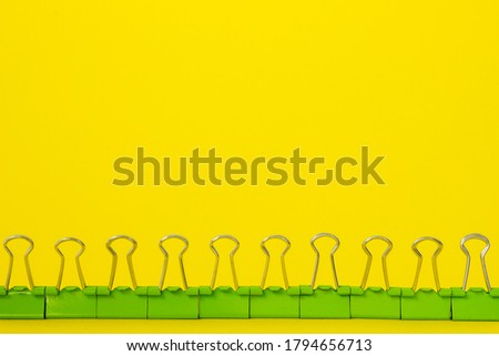 green stationery binders on yellow background