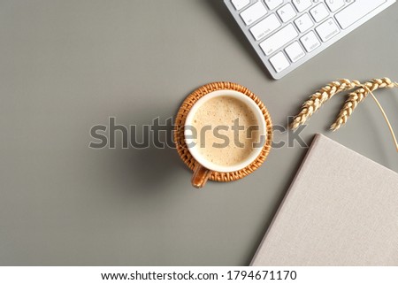 Flat lay, top view office table desk. Workspace with notebook, keyboard, coffee cup, wheat on green background. Autumn style.