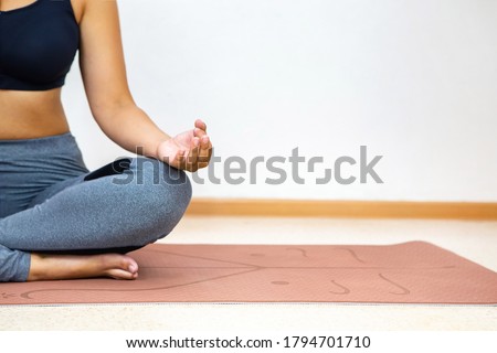the girl in the Lotus position only the body without a face is visible close up on a light background in the room