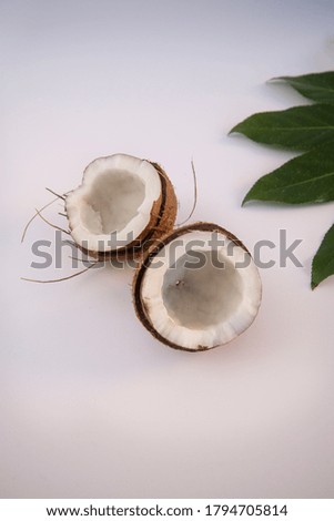 Split into pieces of coconut on the white background with leaf Isolated coconut.