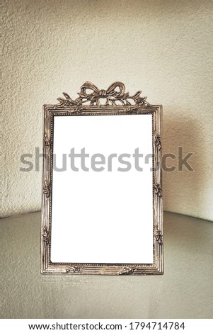 Antique silver photo frame on the table, blank with isolated white background for text. beautiful vintage decoration luxury