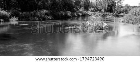 Monochrome image of a chalk river. long exposure smoothing the water.