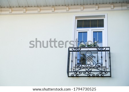 white window with black wrought iron sill