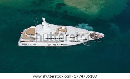 Aerial drone photo of luxury yacht cruising deep blue Aegean sea