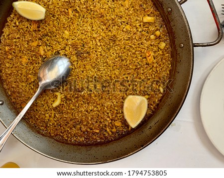Arroz a banda, a delicious traditional meal from Valencia and Alicante (Spain), made with rice, fish and seafood similar to paella Royalty-Free Stock Photo #1794753805