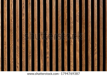 Texture of wood lath wall background. Seamless pattern of modern wall paneling with vertical wooden slats for background Royalty-Free Stock Photo #1794769387