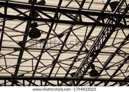 Silhouette photo of metal structure on the roof which shows beautiful pattern of row and branches of abstract art with clear ceiling shows urban lifestyle for decorating in building.