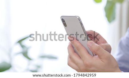 Asian man looking at smartphone