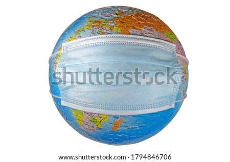 A surgical face mask putting on a world globe protecting the world from pollution and infectious diseases (closeup, isolated on white background) Royalty-Free Stock Photo #1794846706
