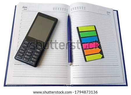 Notebook, pen and cellular telephone on a white background