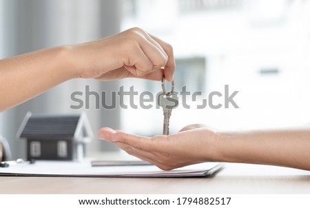 Home sales cell or real estate agent has given the customer the key to the customer who signed the home purchase contract, Negotiating purchase-sale and investment planning concept. Royalty-Free Stock Photo #1794882517