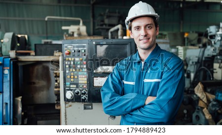 Engineer,Industry and construction concept. Portrait of caucasian Industry factory maintenance engineer wearing uniform and safety helmet in factory. Royalty-Free Stock Photo #1794889423