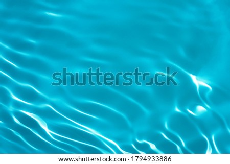 Closeup of calm water surface texture with splashes and bubbles in mint blue color. Trendy fresh abstract nature background. 2021 color trend 