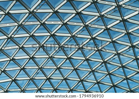 Background texture of sky with triangle frame in front of it. Triangle shaped windows . Decorative roof style. High resolution image for background.