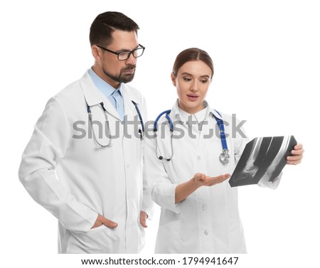 Orthopedists working with X-ray picture on white background