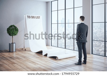 Businessman looking on drawing do it plan  on poster. Motivation and leadership concept
