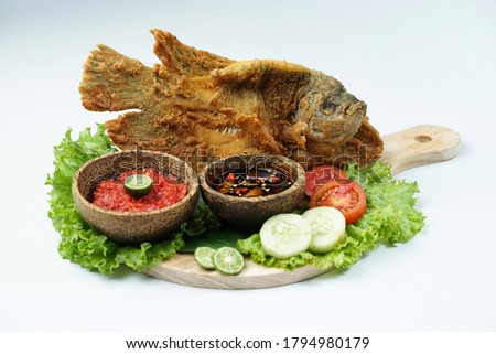 Flying fried fish with raw sambal on isolated white background. Usually used for menu list pictures or food pictures in restaurants. Top view