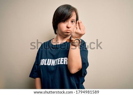 Young down syndrome volunteer woman wearing social care charity t-shirt Doing Italian gesture with hand and fingers confident expression