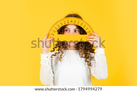 Back to school. Student learning geometry yellow background. Measure angles in degrees. School lessons. Adorable cute pupil. She loves studying. Small girl holding protractor for geometry lesson.
