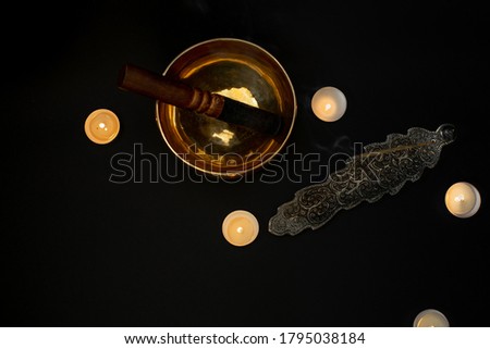 Singing bowl flat lay on a black background.  