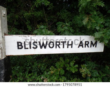 Finger board style sign on a country lane leading to Blisworth Arm, a canal village, in  Northamptonshire, England.