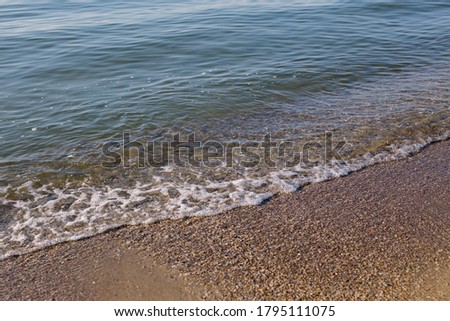 
Sea shore. Tide of waves, calm atmosphere. Color photography, horizontal.