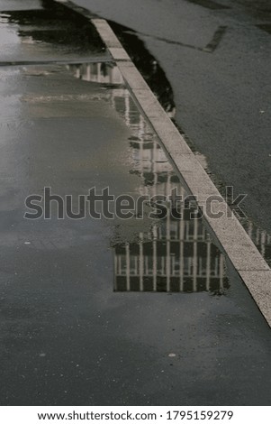 street reflections on puddles in city streets