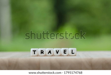 Dice the word "TRAVEL" Text dice cube concept / Letter dices alphabet on wooden background. Block of alphabet studded on the floor. coppy space.