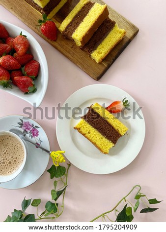 Lapis Malang is an Indonesian Three Layer rich sponge Cake with yellow-chocolate-yellowcake and strawberry jam in between. 