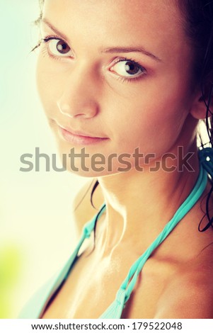 Young wet woman in blue bikini 