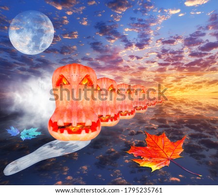 Concept of coming halloween: bright supermoon in night dramatic clouds with horror flaming face of halloween pumpkins appearing from horizon 