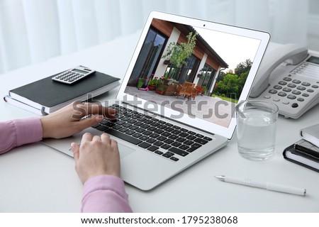 Businesswoman or real estate agent looking through online property portfolio, closeup Royalty-Free Stock Photo #1795238068